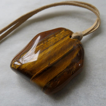 Tiger's eye, drilled stone on leather No.9